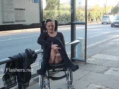 Nudistin im Rollstuhl zeigt outdoor alles